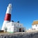 A man walks into the Portland Bill Lighthouse, situated on a coastal cliff next to a keeper’s cottage